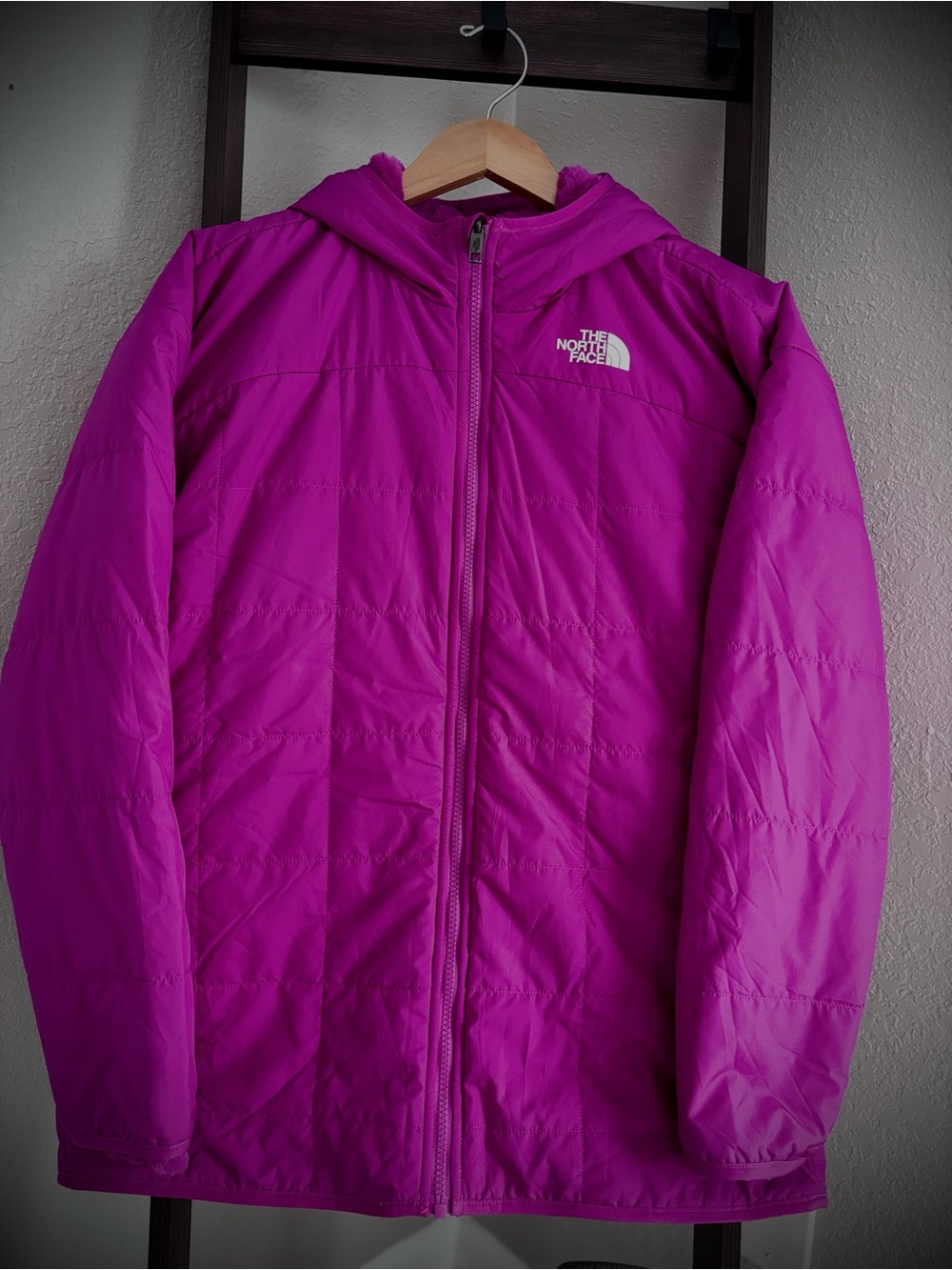 The North Face women's reversible quilted hooded jacket in magenta.